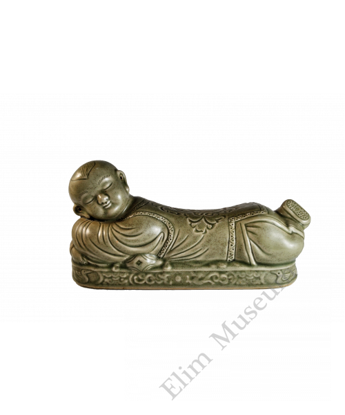 1723 A Yaozhou ware celadon pillow in the form of a reclining boy