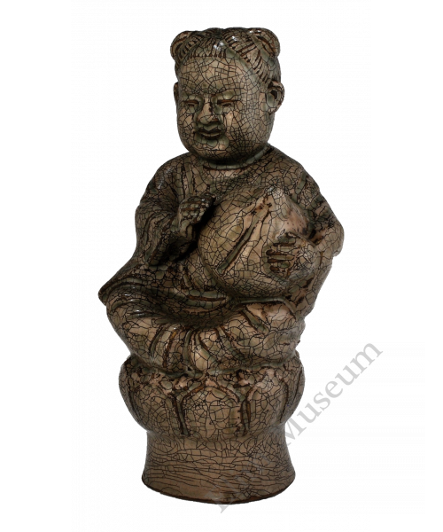 1724  A Yue-ware hand-scupted "peach boy"  seated on lotus
