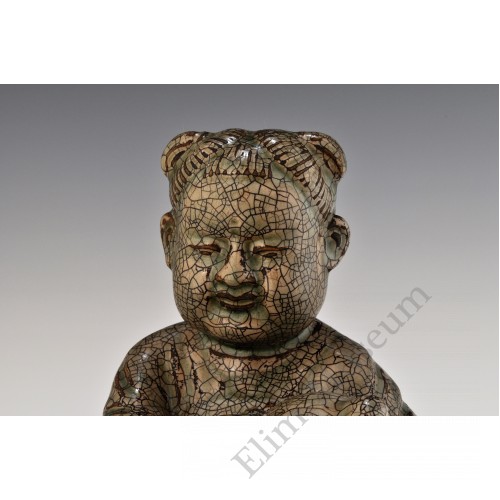 1724  A Yue-ware hand-scupted "peach boy"  seated on lotus