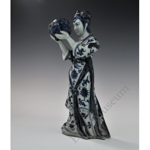 1727  A underglaze blue statue of a Court Maid holding a peach