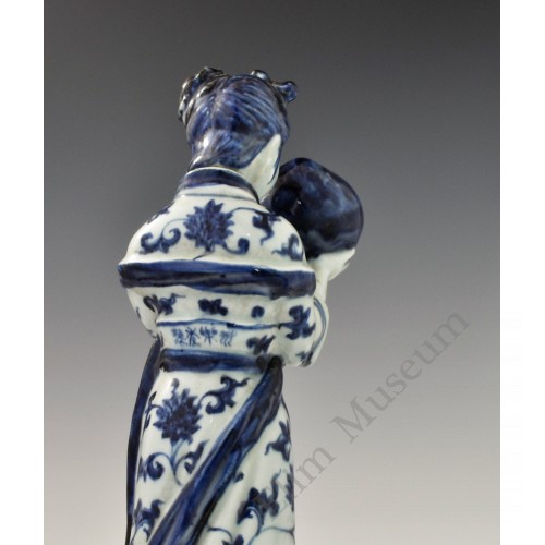 1727  A underglaze blue statue of a Court Maid holding a peach