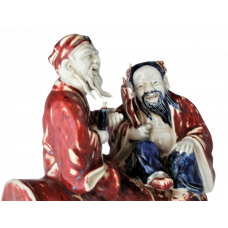 1731 A sculpture in under glaze blue & red of figures of the "Eight Immortals" 