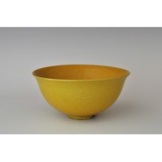 1754  A porcelain bowl with yellowish glaze and incised peony scrolls